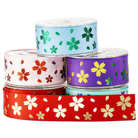 Flor impressa do arco-íris na fita roxa do Grosgrain para o empacotamento dos doces